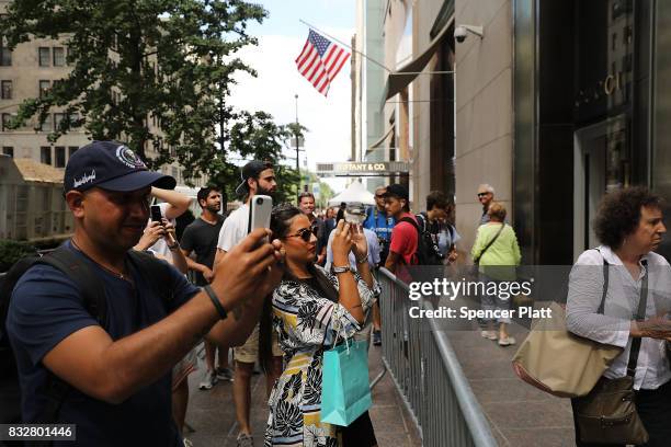 People walk outside of Trump Tower after it re-opened to the public following the departure of US President Donald Trump on August 16, 2017 in New...