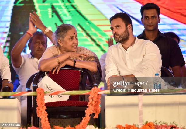 Margaret Alva and Congress Vice President Rahul Gandhi talk to each other during a public meeting at National College ground on August 16, 2017 in...