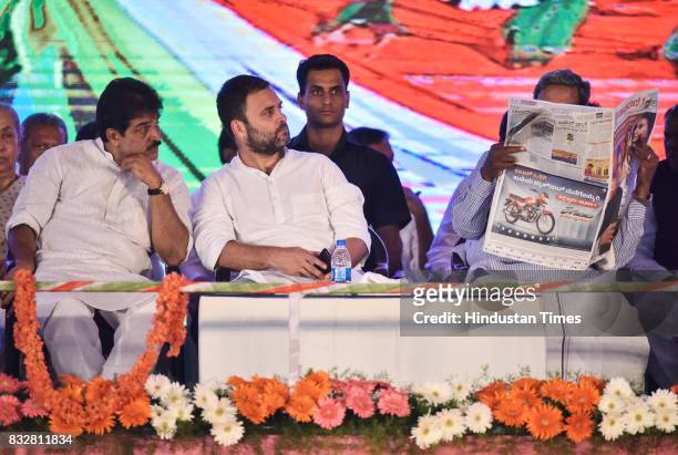 Venugopal, Congress Vice President Rahul Gandhi listen to KPCC President's speech as Karnataka Chief Minister Siddaramaiah reads newspaper during a...