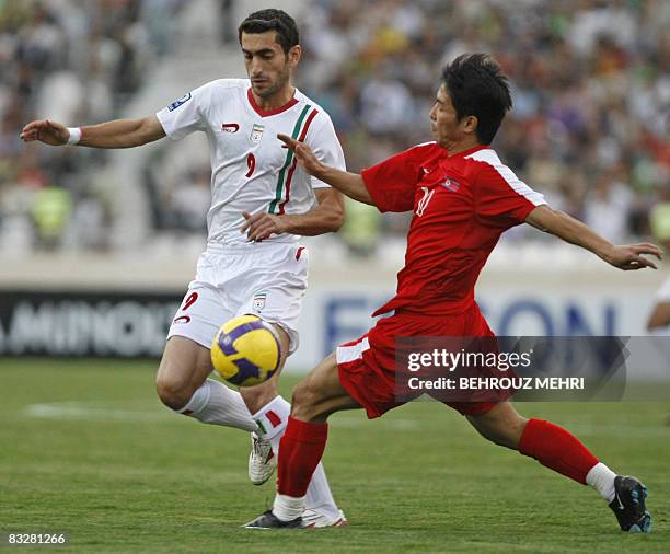 Iran's Mojtaba Jabbari and North Korea's Yong Jo Hong compete during their group two Asian qualifying match for the 2010 World Cup at Azadi stadium...
