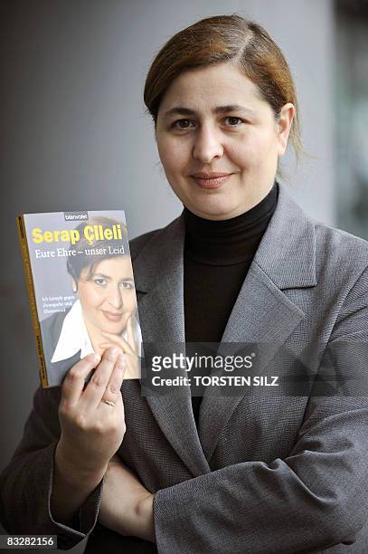 German author of Turkish origin Serap Cileli poses with her latest book "Eure Ehre - unser Leid" at the Frankfurt Book Fair on October 15, 2008....