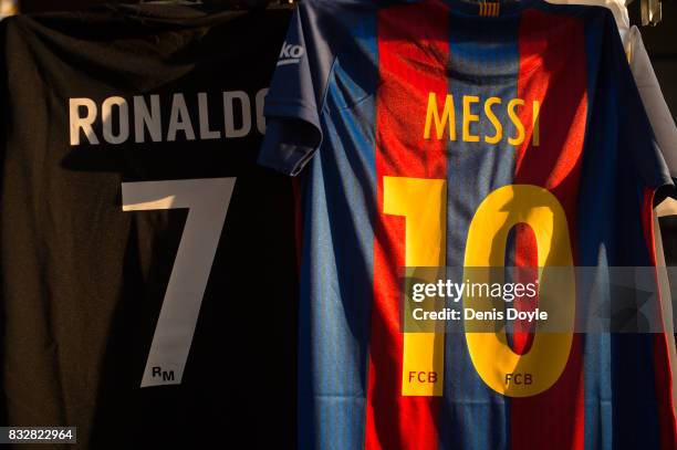 The shirts of Cristiano Ronaldo of Real Madrid CF and Lionel Messi of FC Barcelona are for sale at a stall outside the Santiago Bernabeu stadium...