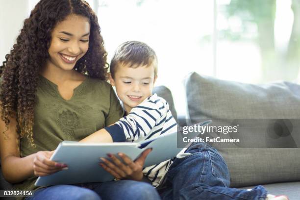 happy readers - babysitter stock pictures, royalty-free photos & images