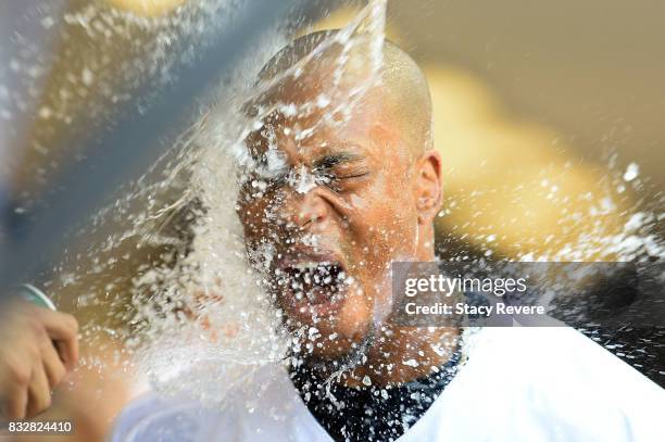 Keon Broxton of the Milwaukee Brewers is doused with water following his second home run of the day during the seventh inning of a game against the...