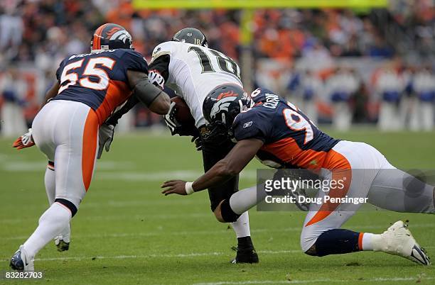 Wide receiver Matt Jones of the Jacksonville Jaguars makes a reception and is tackled by D.J. Williams and Tim Crowder of the Denver Broncos during...