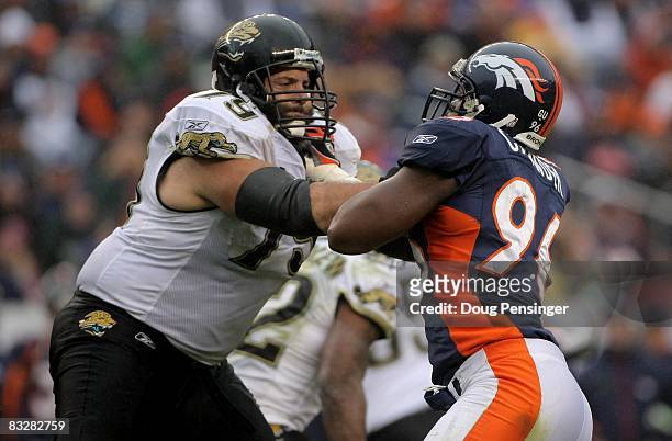 Offensive tackle Tony Pashos of the Jacksonville Jaguars blocks the rush defensive end Tim Crowder of the Denver Broncos during NFL action at Invesco...