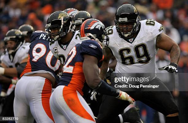 Offensive tackle Khalif Barnes of the Jacksonville Jaguars blocks against Elvis Dumervil of the Denver Broncos during NFL action at Invesco Field at...