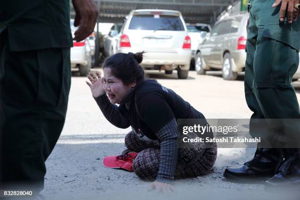 Boeng Kak community activist Bo Chhor Vy protests outside the Appeal Court after a judge upheld a 30-month prison sentence against prominent land...