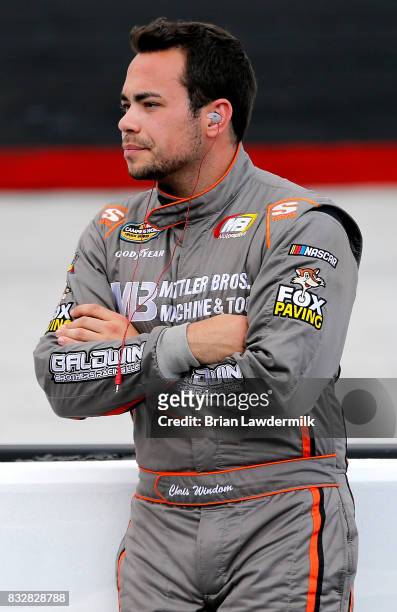 Chris Windom, driver of the Baldwin Brothers Chevrolet, stands on pit road during qualifying for the NASCAR Camping World Truck Series UNOH 200 at...