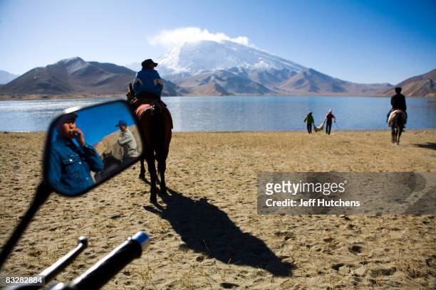 On the shores of Lake Karakul, a nomadic Kyrgyz tribesmen ready for a game of "goat grab" on horseback on October 15, 2007 in Xinjiang, China.
