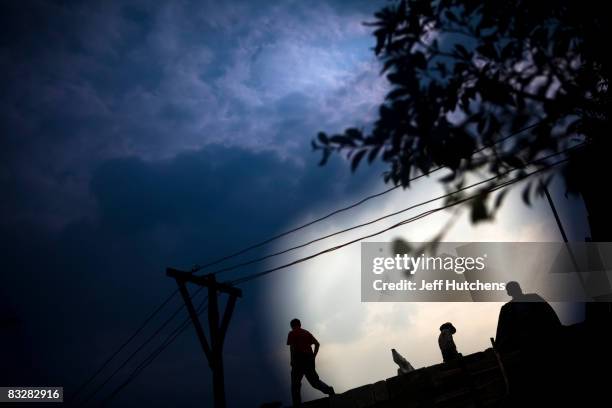 Builders work in the streets of a newly created town built to house forcibly relocated residents whose homes are being intentionally flooded during...