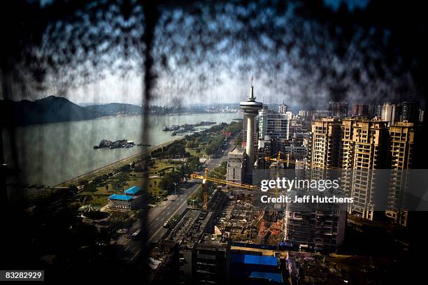 Lamp sits in front of a window overlooking the town of Yichang on the Yangtze River near the Three Gorges Dam Project on November 2, 2007 outside of...