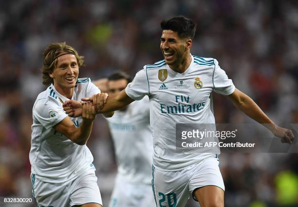 Real Madrid's midfielder Marco Asensio celebrates with Real Madrid's Croatian midfielder Luka Modric after scoring the opener during the second leg...