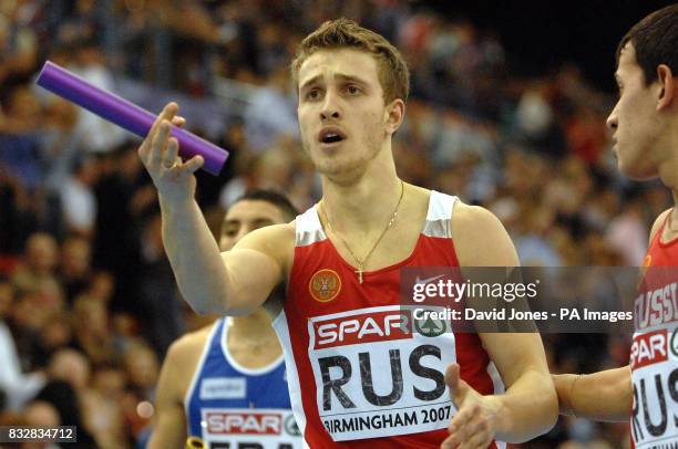 Russia's final leg runner Artem Sergeyenkov protests to the German team atfter the 4x400m relay during the European Athletics Indoor Championships at...