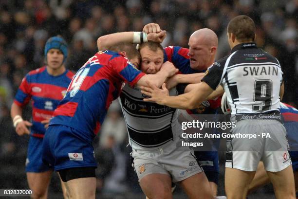 Hull FC's Gareth Carvell is tackled by Wakefield Trinity Wildcats' Paul March and Richard Moore during the engage Super League match at the KC...