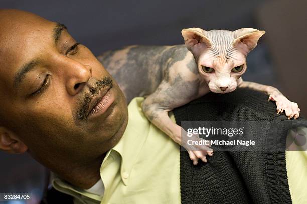 David White, of Wayne, New Jersey, holds his Grand Champion sphynx, Good Golly Miss Molly, at a press preview for the 6th Annual CFA Iams Cat...