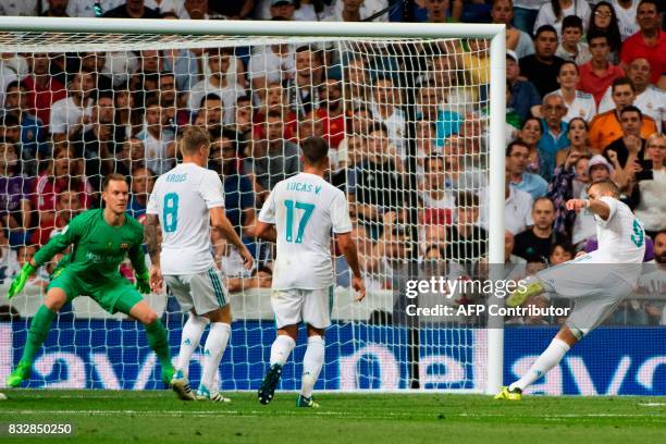 Real Madrid's French forward Karim Benzema scores their second goal during the second leg of the Spanish Supercup football match Real Madrid vs FC...