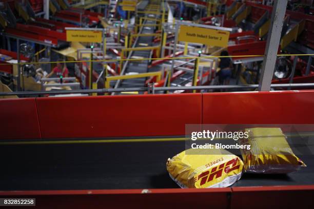 Packages move down conveyor belts while being sorted at the DHL Worldwide Express hub of Cincinnati/Northern Kentucky International Airport in...