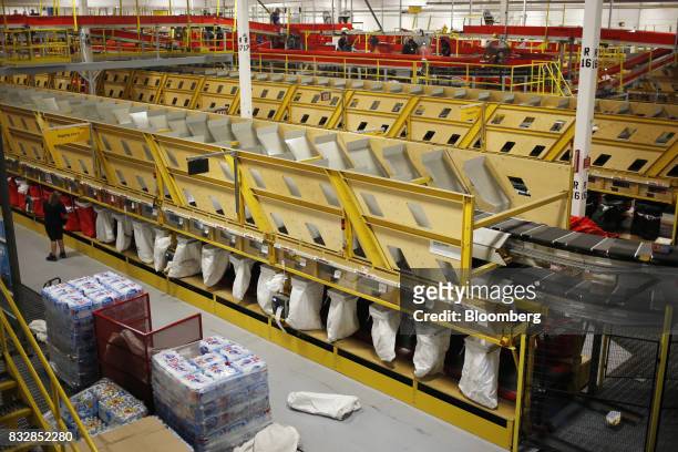 Packages move down conveyor belts while being sorted at the DHL Worldwide Express hub of Cincinnati/Northern Kentucky International Airport in...