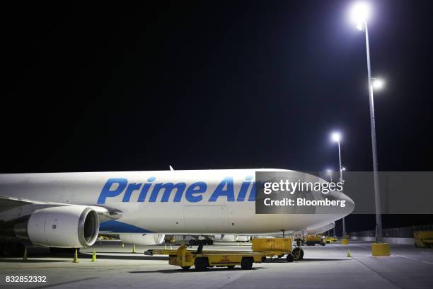 An Amazon.com Inc. Prime Air cargo jet sits parked at the DHL Worldwide Express hub of Cincinnati/Northern Kentucky International Airport in Hebron,...