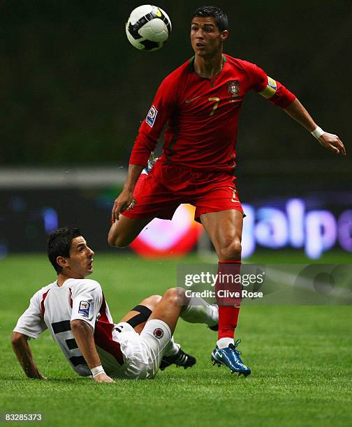 Cristiano Ronaldo of Portugal is challanged by Kristi Vangjeli of Albania during the FIFA2010 Group One World Cup Qualifying match between Portugal...