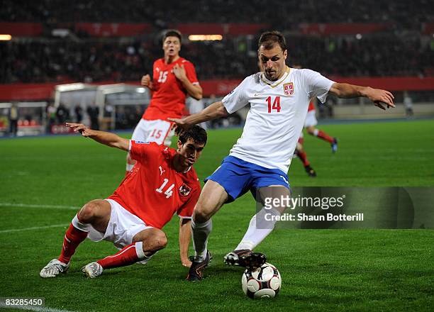 Milan Jovanovic of Serbia is challenged by Gyorgy Garics of Austria during the FIFA 2010 World Cup Qualifying Group 7 match between Austria and...