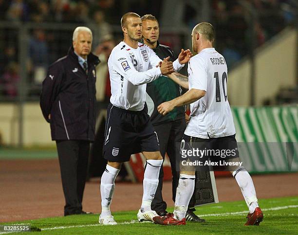 David Beckham of England congratulates Wayne Rooney during their substitution during the FIFA2010 World Cup Qualifying group six match between...