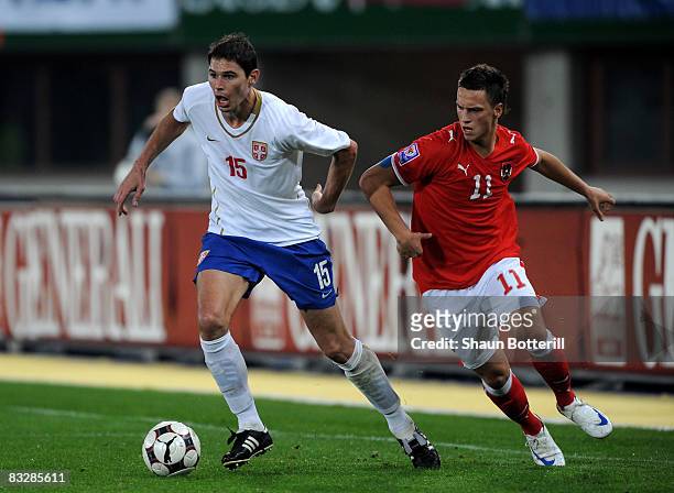 Nikola Zigic of Serbia holds off a challenge from Marko Arnautovic of Austria during the FIFA 2010 World Cup Qualifying Group 7 match between Austria...