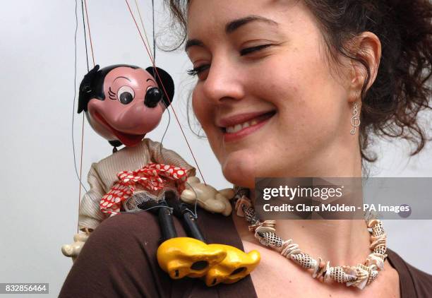 Pelham puppet of Minnie Mouse rests on the shoulder of Christie's press officer Zoe Schoon, before going on sale at the London auction house next...