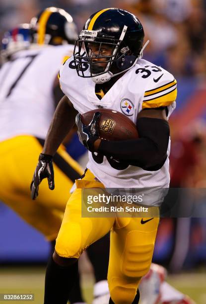 Fitzgerald Toussaint of the Pittsburgh Steelers in action against the New York Giants during an NFL preseason game at MetLife Stadium on August 11,...