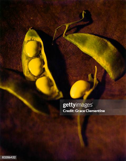 lima beans with pods on wood surface - butter bean pods stock pictures, royalty-free photos & images