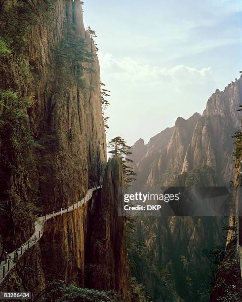 pathway winding through chinese mountian landscape - anhui province photos et images de collection