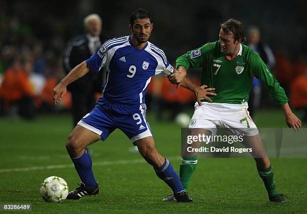 Ioannis Okkas of Cyprus holds off Aiden McGeady during the World Cup qualifying match between the Republic of Ireland and Cyprus at Croke Park on...