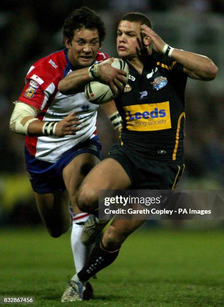 Leeds Rhinos' Jordan Tansey gets past Wakefield Trinity Wildcats' Olivier Elima during the engage Super League match at Belle Vue, Wakefield.