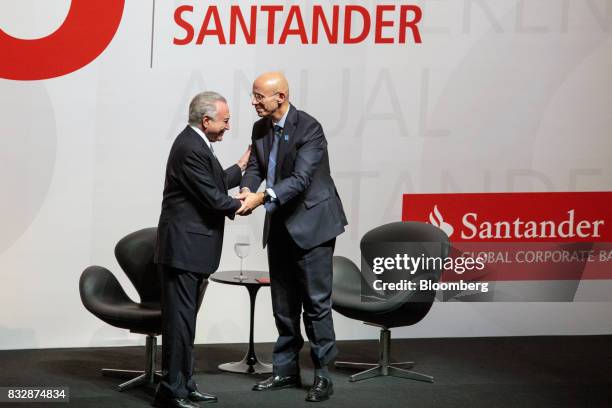 Sergio Rial, chief executive officer for Banco Santander Brasil SA, right, shakes hands with Michel Temer, Brazil's president, during the Annual...