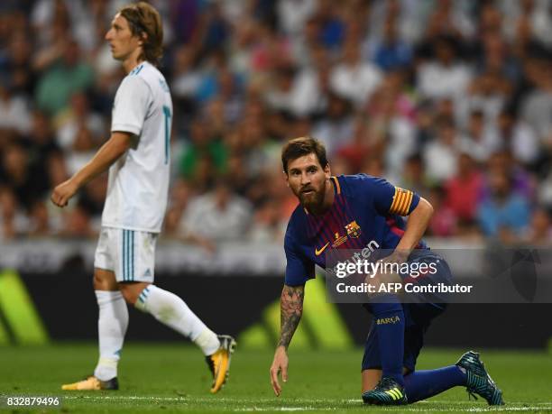 Barcelona's Argentinian forward Lionel Messi stands up after falling during the second leg of the Spanish Supercup football match Real Madrid vs FC...