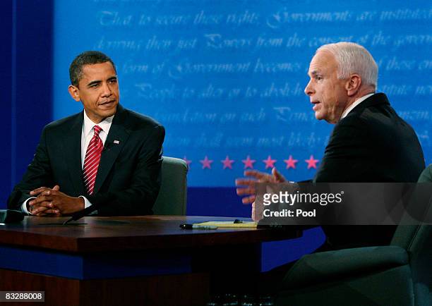 Democratic presidential nominee Sen. Barack Obama listens as Republican presidential nominee Sen. John McCain speaks during the third presidential...
