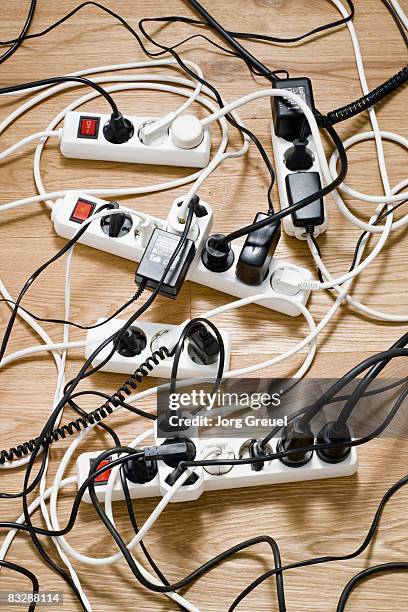 multiple power strips on floor - fio de extensão imagens e fotografias de stock