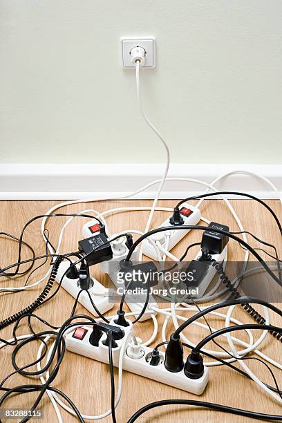 power strips connected to wall outlet - cavi foto e immagini stock