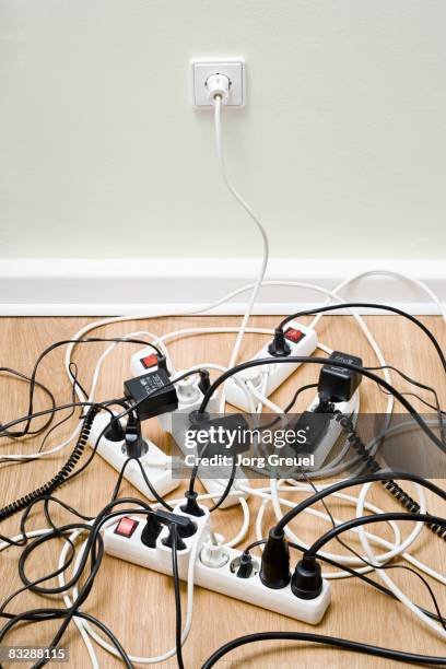 power strips connected to wall outlet - tangled extension cords stock pictures, royalty-free photos & images