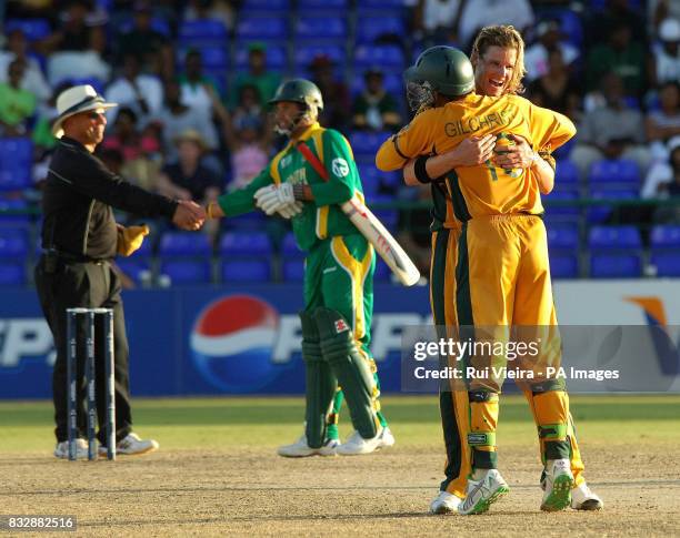 Australia's Nathan Bracken is congratulated by Adam Gilchrist after he took South Africa's last wicket Makhaya Ntini during the ICC Cricket World Cup...