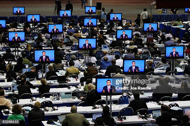 Democratic presidential nominee U.S. Sen. Barack Obama is seen on television screens in the press center as reporters listen to him speak during the...