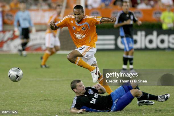 Ricardo Clark of the Houston Dynamo hops over Eric Denton of the San Jose Earthquakes on October 15, 2008 at Robertson Stadium in Houston, Texas.