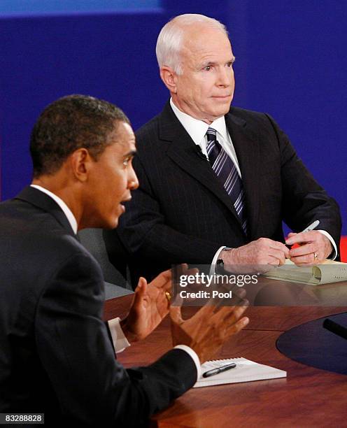 Democratic presidential nominee Sen. Barack Obama speaks as Republican presidential nominee Sen. John McCain listens during the third presidential...