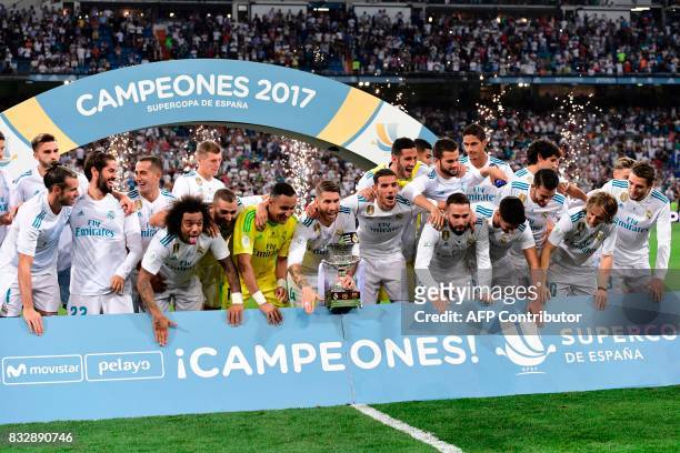 Real Madrid players celebrate their Supercup trophy after winning the second leg of the Spanish Supercup football match Real Madrid vs FC Barcelona...