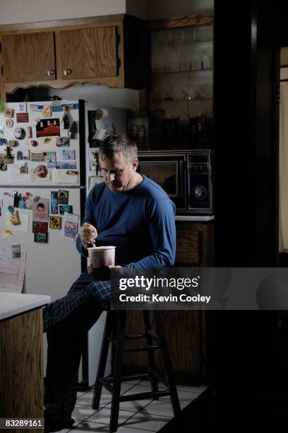 Middle Aged Man Eating Midnight Snack, Foto stock