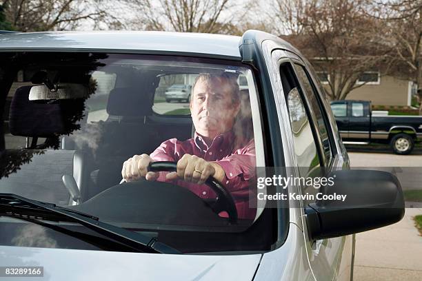 middle aged man thinking in car - car on driveway bildbanksfoton och bilder