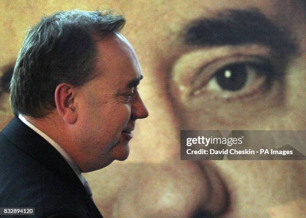 Leader of the Scottish National Party Alex Salmond walks past his poster at the SNP campaign launch in Edinburgh.