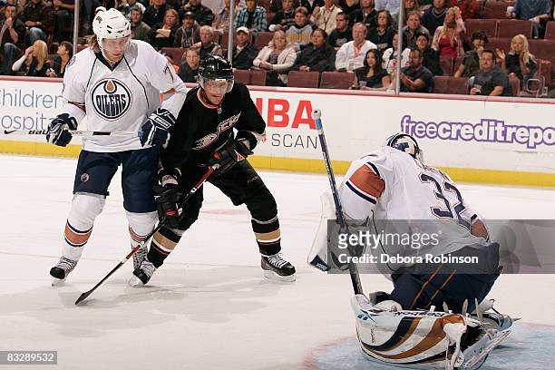 Tom Gilbert and Mathieu Garon of the Edmonton Oilers defend as Teemu Selanne of the Anaheim Ducks makes a shot on goal during the game on October 15,...