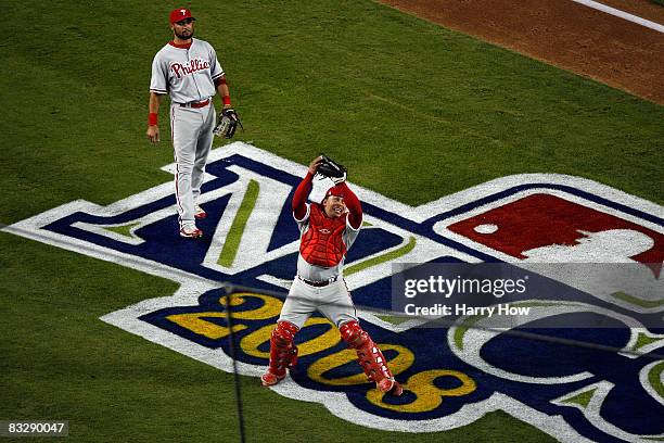 Catcher Carlos Ruiz of the Philadelphia Phillies makes the final catch of a Nomar Garciaparra of the Los Angeles Dodgers pop fly as Ruiz and the...